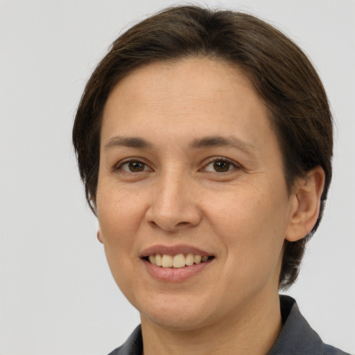 Joyful white adult female with medium  brown hair and brown eyes