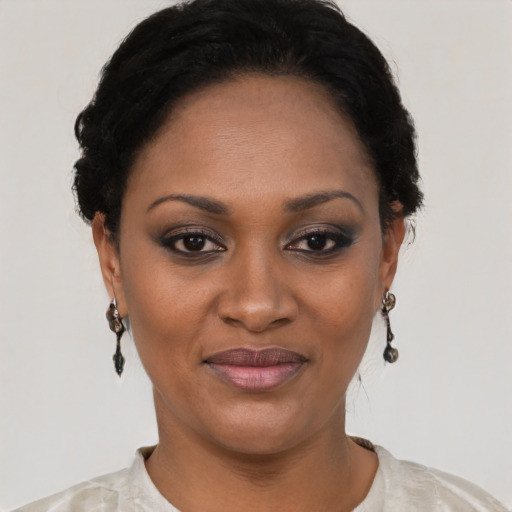 Joyful black young-adult female with short  black hair and brown eyes