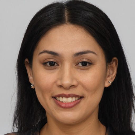 Joyful asian young-adult female with long  brown hair and brown eyes
