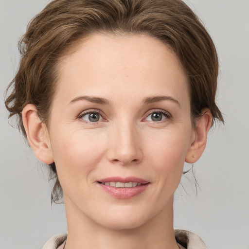 Joyful white young-adult female with medium  brown hair and grey eyes