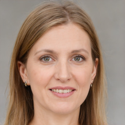 Joyful white adult female with long  brown hair and grey eyes