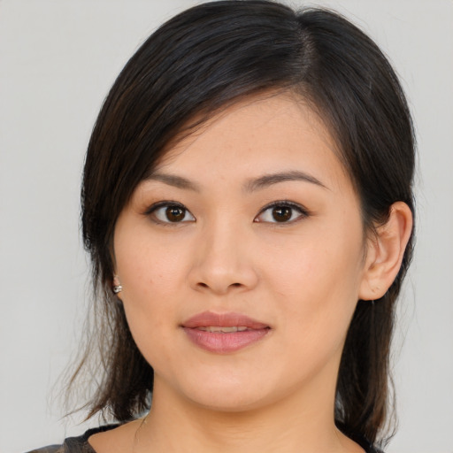 Joyful asian young-adult female with medium  brown hair and brown eyes