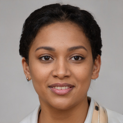 Joyful latino young-adult female with short  brown hair and brown eyes