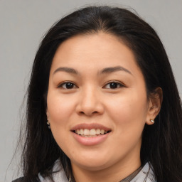 Joyful asian young-adult female with medium  brown hair and brown eyes