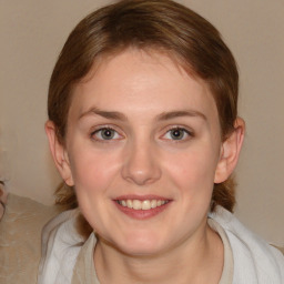 Joyful white young-adult female with medium  brown hair and blue eyes