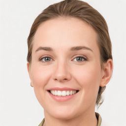 Joyful white young-adult female with medium  brown hair and blue eyes