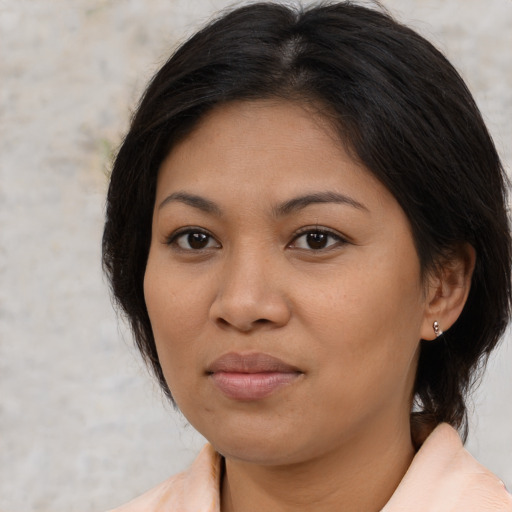 Joyful asian adult female with medium  brown hair and brown eyes