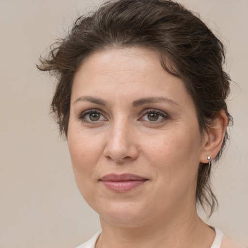 Joyful white adult female with medium  brown hair and brown eyes
