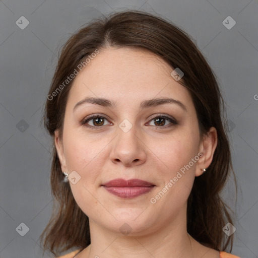 Joyful white adult female with medium  brown hair and brown eyes