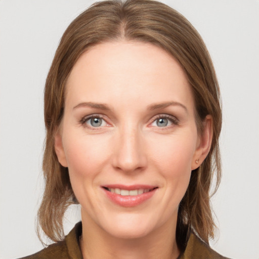 Joyful white young-adult female with medium  brown hair and blue eyes