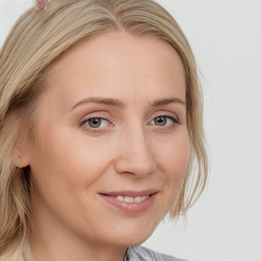 Joyful white young-adult female with medium  blond hair and brown eyes