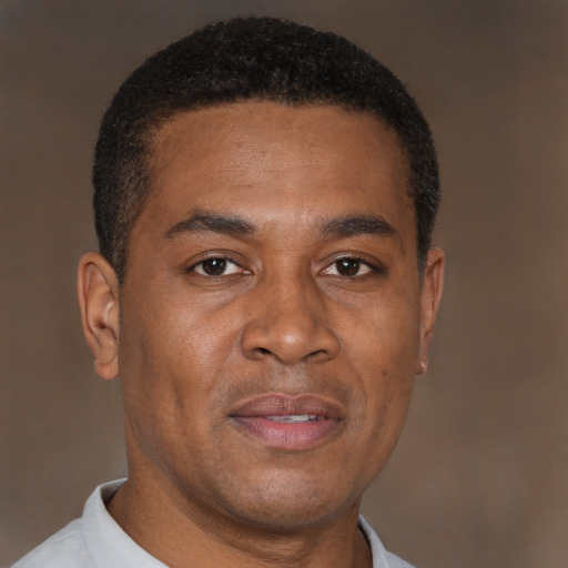 Joyful latino adult male with short  brown hair and brown eyes