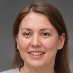 Joyful white adult female with medium  brown hair and grey eyes