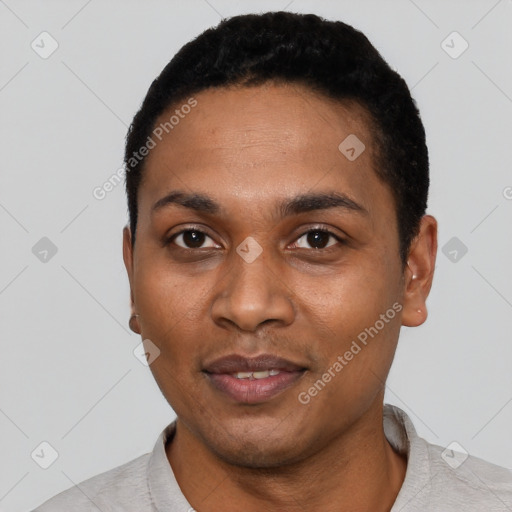 Joyful black young-adult male with short  black hair and brown eyes