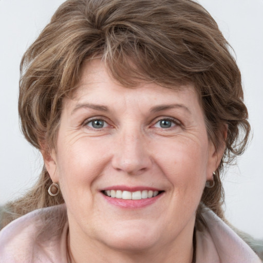 Joyful white adult female with medium  brown hair and grey eyes