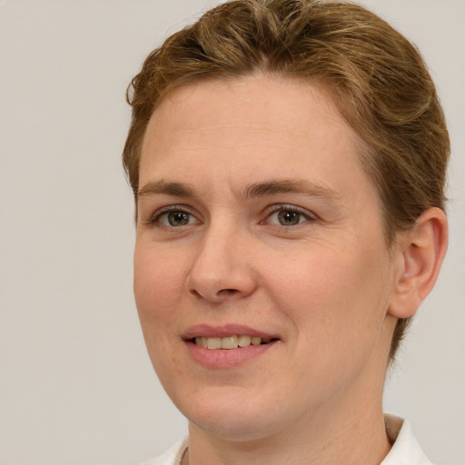 Joyful white adult female with short  brown hair and green eyes