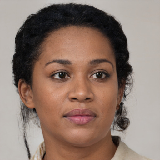 Joyful black young-adult female with medium  brown hair and brown eyes