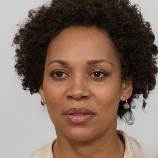 Joyful black adult female with short  brown hair and brown eyes