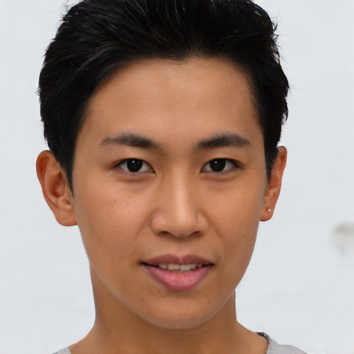 Joyful asian young-adult male with short  brown hair and brown eyes