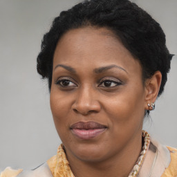 Joyful black adult female with medium  brown hair and brown eyes