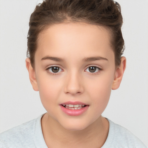 Joyful white child female with short  brown hair and brown eyes