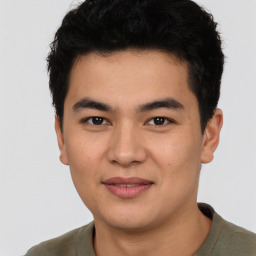 Joyful asian young-adult male with short  black hair and brown eyes