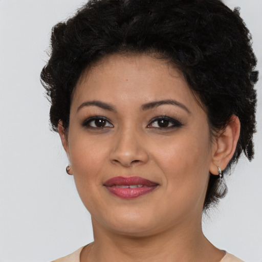 Joyful latino young-adult female with short  brown hair and brown eyes