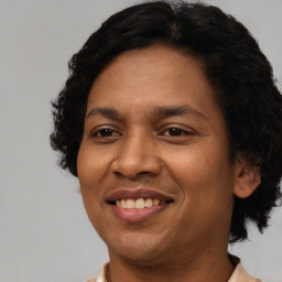 Joyful black adult female with short  black hair and brown eyes