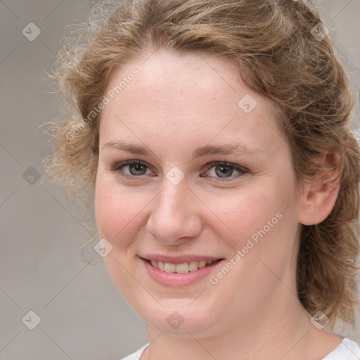 Joyful white young-adult female with medium  brown hair and blue eyes