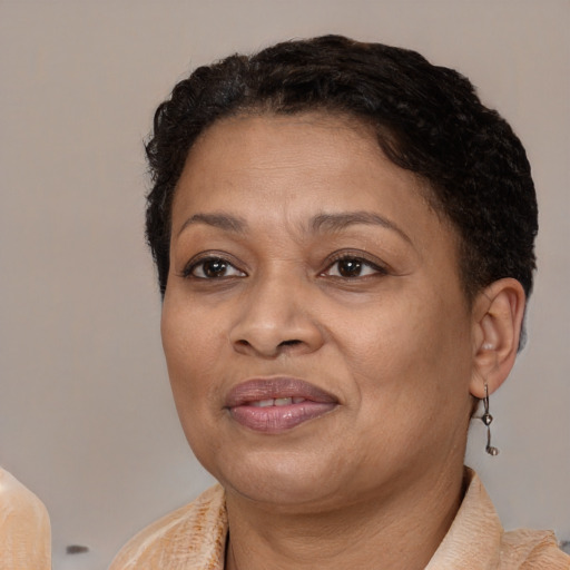 Joyful latino adult female with short  brown hair and brown eyes