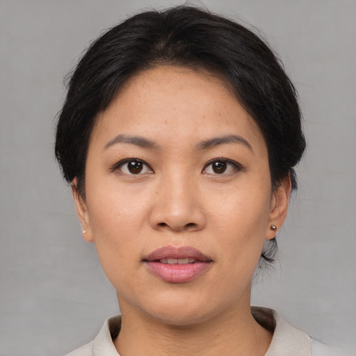 Joyful asian adult female with short  black hair and brown eyes