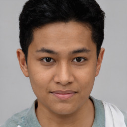 Joyful latino young-adult male with short  brown hair and brown eyes