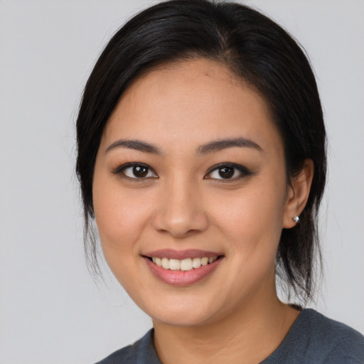 Joyful asian young-adult female with medium  black hair and brown eyes