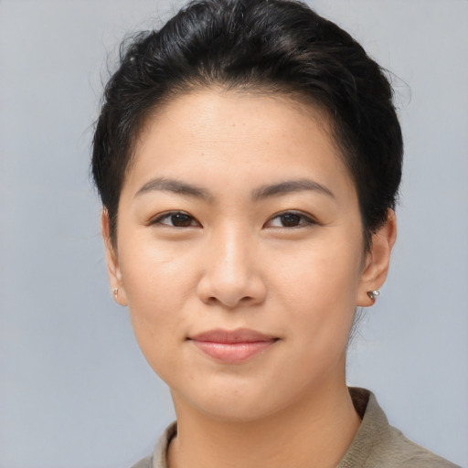 Joyful asian young-adult female with short  brown hair and brown eyes