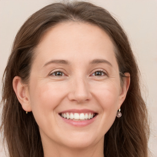 Joyful white young-adult female with long  brown hair and grey eyes