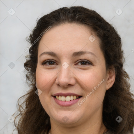 Joyful white adult female with long  brown hair and brown eyes