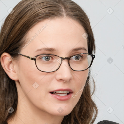 Joyful white young-adult female with long  brown hair and blue eyes