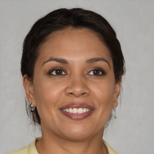 Joyful white adult female with medium  brown hair and brown eyes