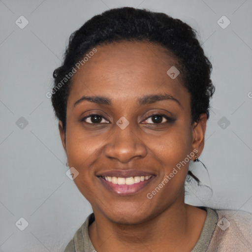 Joyful black young-adult female with short  black hair and brown eyes