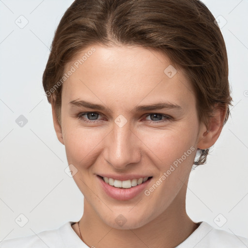 Joyful white young-adult female with short  brown hair and grey eyes