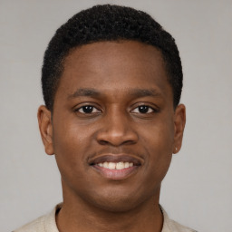 Joyful black young-adult male with short  brown hair and brown eyes