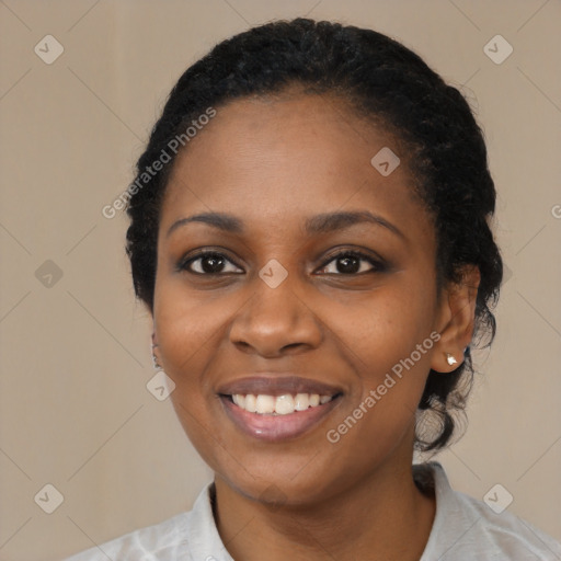 Joyful black young-adult female with medium  black hair and brown eyes