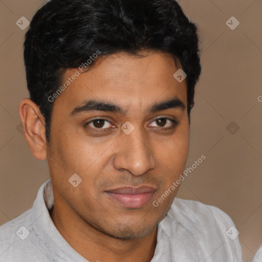 Joyful latino young-adult male with short  brown hair and brown eyes