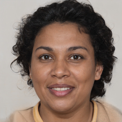 Joyful black adult female with short  brown hair and brown eyes