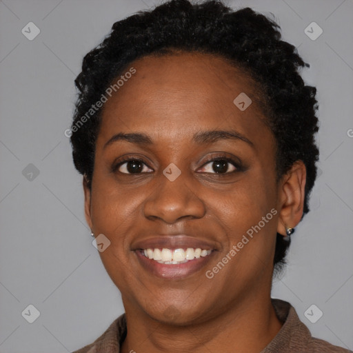 Joyful black young-adult female with short  black hair and brown eyes