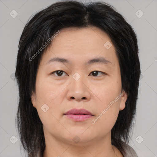 Joyful asian adult female with medium  brown hair and brown eyes