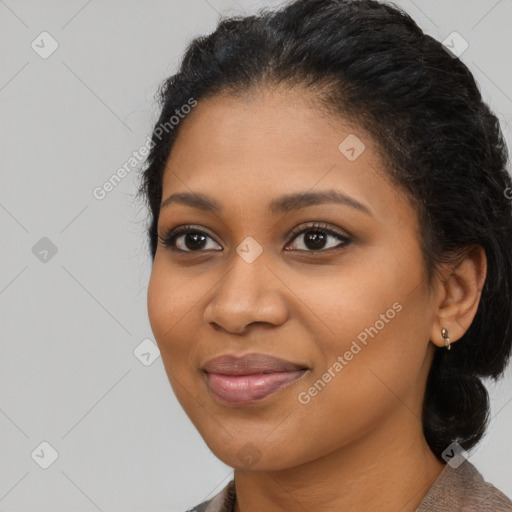 Joyful black young-adult female with long  black hair and brown eyes