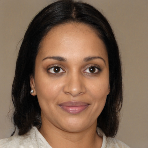 Joyful black young-adult female with medium  brown hair and brown eyes