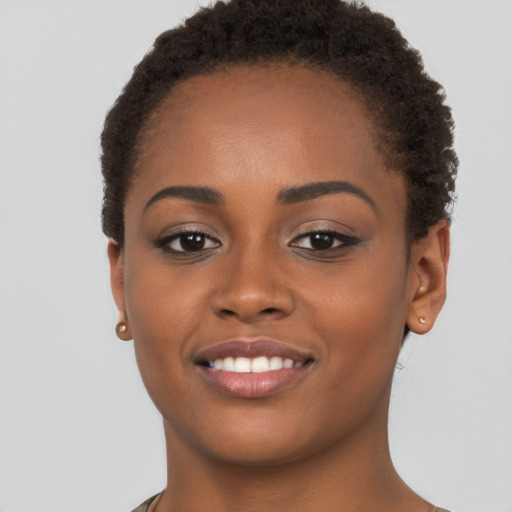 Joyful black young-adult female with short  brown hair and brown eyes