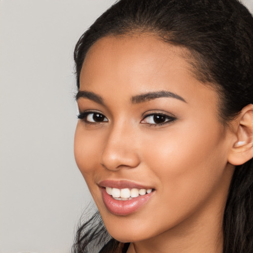 Joyful latino young-adult female with long  black hair and brown eyes